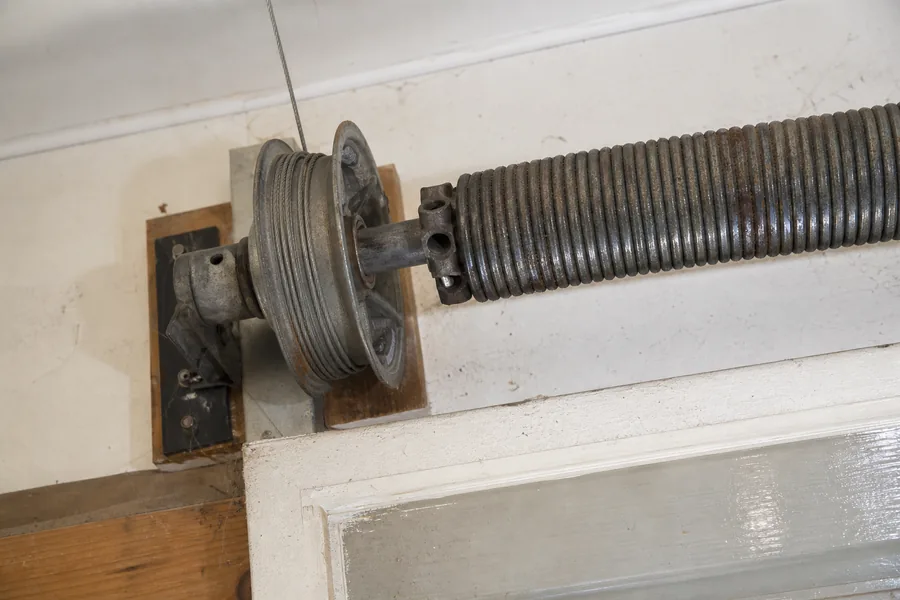 Torsion spring, shaft and cable drum above a garage door in Georgetown, TX